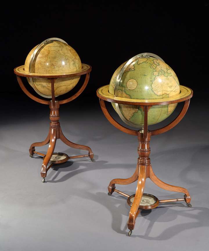 A pair of regency 18-inch globes on mahogany stands